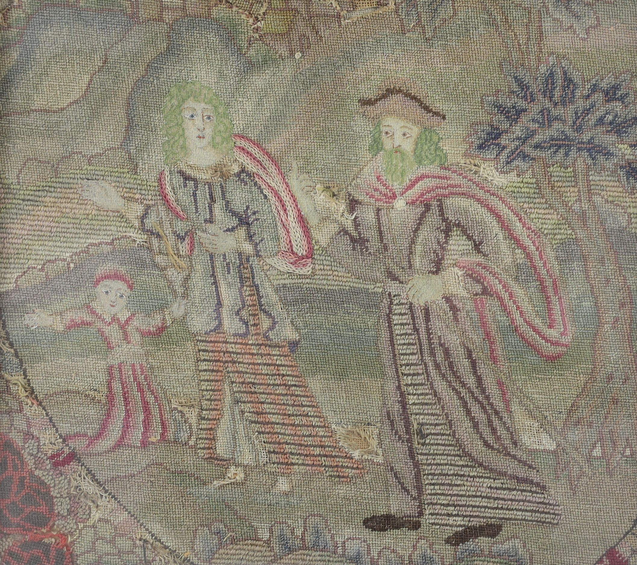 A embroidered panel, decorated with a couple accompanied by a child, in woodland setting before a distant town, in a later gilt-bordered ebonised frame, Northern Europe, 17th century 27 x 31cm